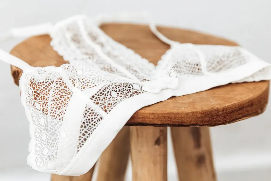 White delicate lace bra on a wood  stool