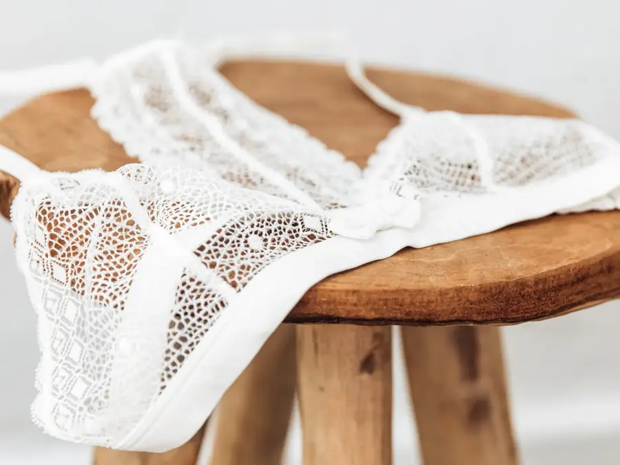 White delicate lace bra on a wood  stool