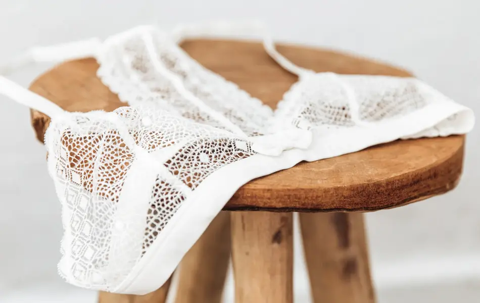 White delicate lace bra on a wood  stool