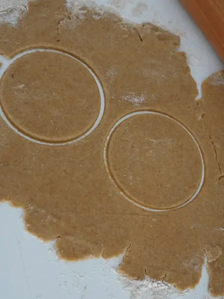 Bakebrett med utkjevelet deig og stukket ut to sirkler