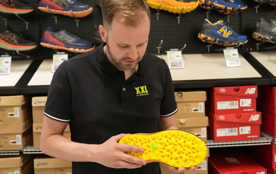 Mann som holder en sko