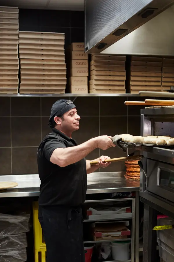 kokk som lager pizza hos grand caffe venezia