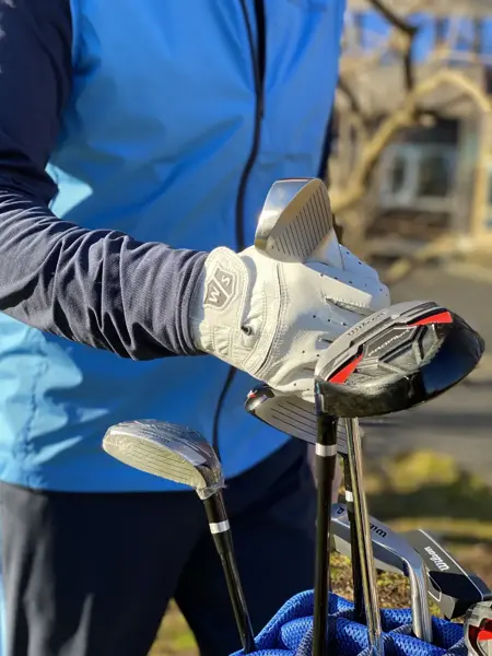 Person som holder en golfkølle