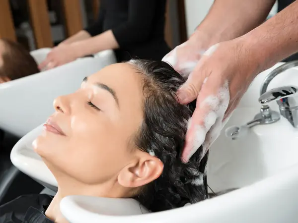 Woman is having a hair wash.