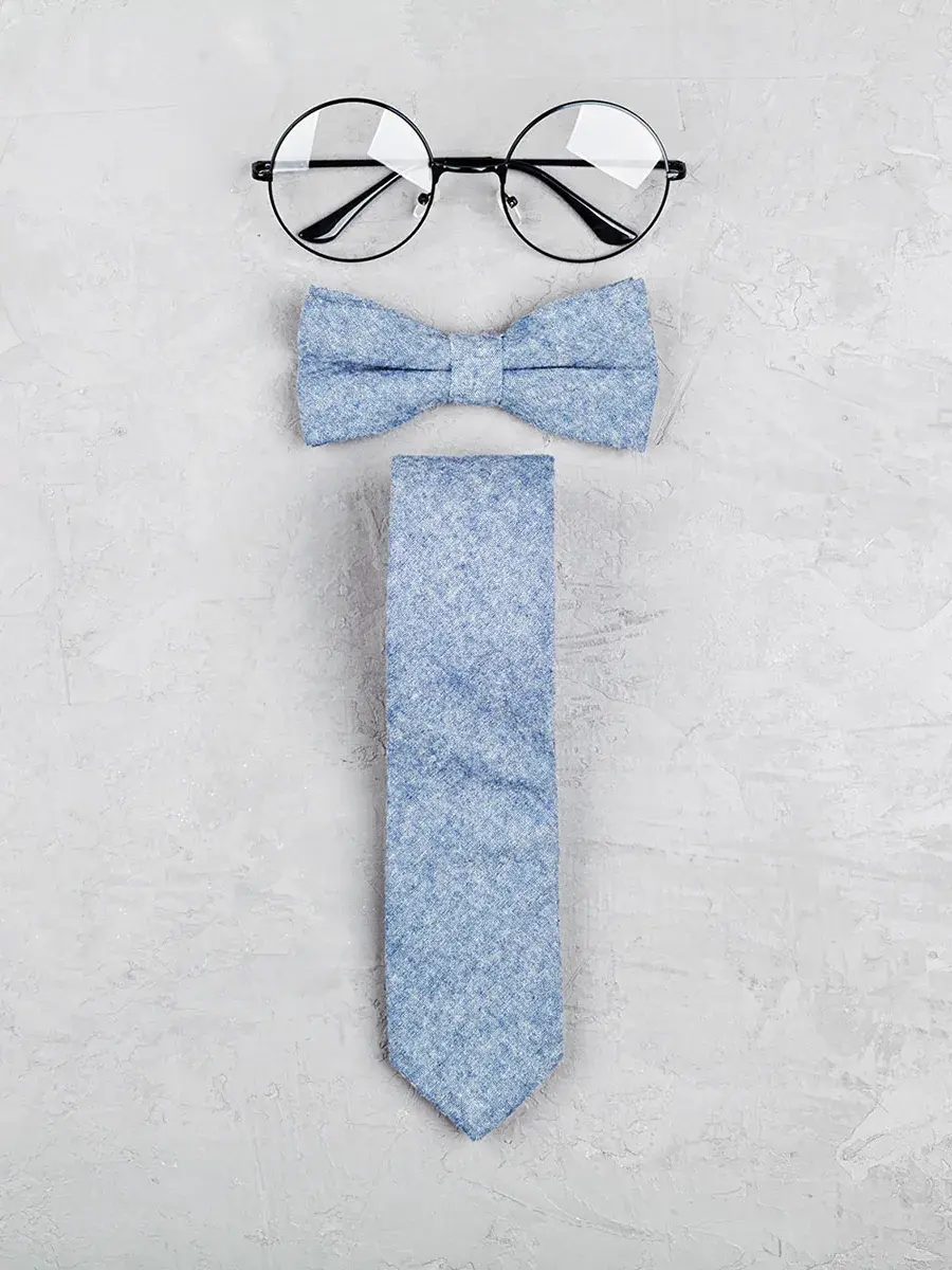 Happy Fathers Day background with glasses, necktie and bowtie on stone table top view in flat lay style.