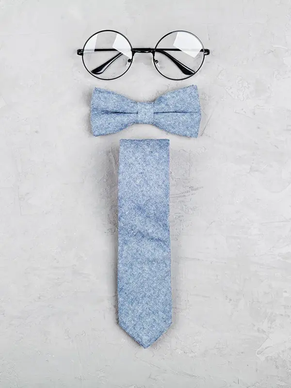 Happy Fathers Day background with glasses, necktie and bowtie on stone table top view in flat lay style.