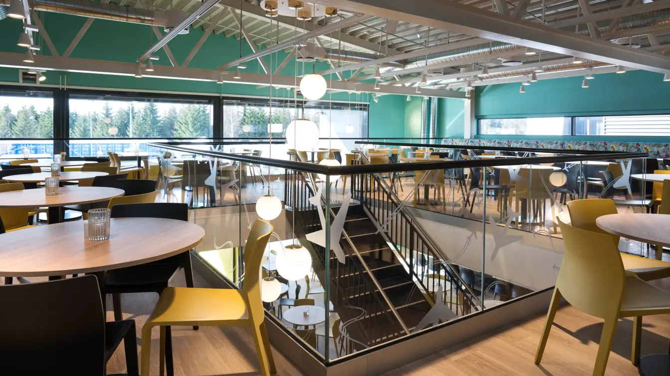 Messanin med runde ståbord, høyt under taket og barstoler på Thon Hotel Gardermoen