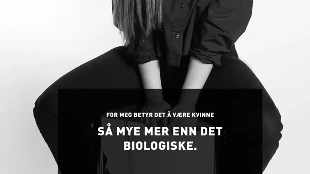 Utsnitt av kvinne med lyst hår som sitter på en høy krakk og utsagnet For meg betyr det å være kvinne så mye mer enn det biologiske.