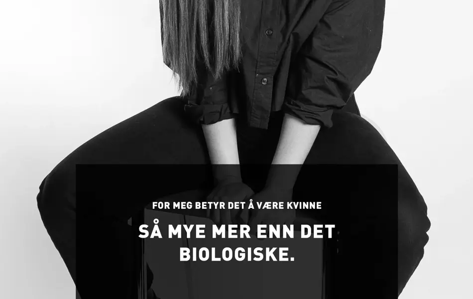 Utsnitt av kvinne med lyst hår som sitter på en høy krakk og utsagnet For meg betyr det å være kvinne så mye mer enn det biologiske.