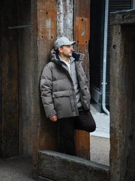 Mann som lener seg på en stolpe