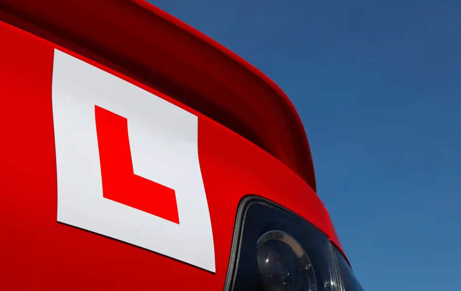 Learner Plate on Rear of Red Car looking up towards sky