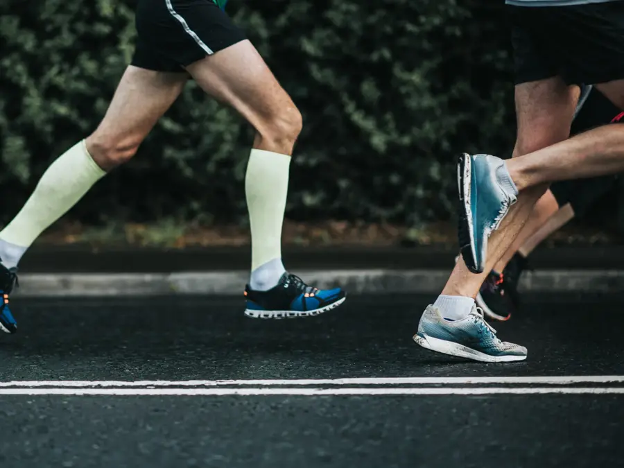 Joggers running on tarmac.