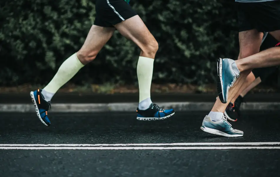 Joggers running on tarmac.