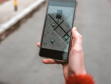 Photo of Tourist, Unrecognizable Person using map in phone app to navigate and find location of hotel in city during the day. Woman with smartphone using GPS service. Travel and navigation concept. Rear view of Caucasian woman walking in the street using her mobile phone with copy space.