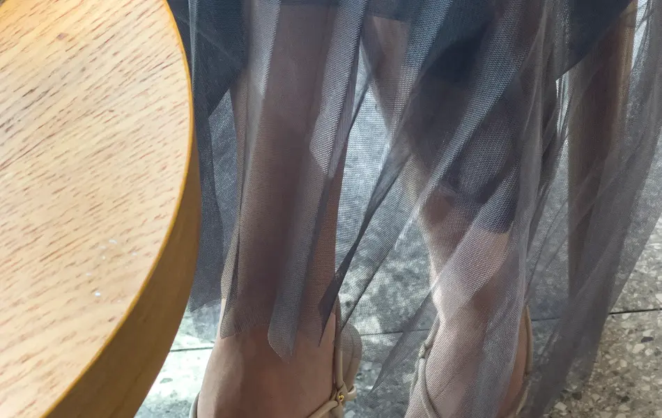 Woman crossed her legs gracefully at the coffee table