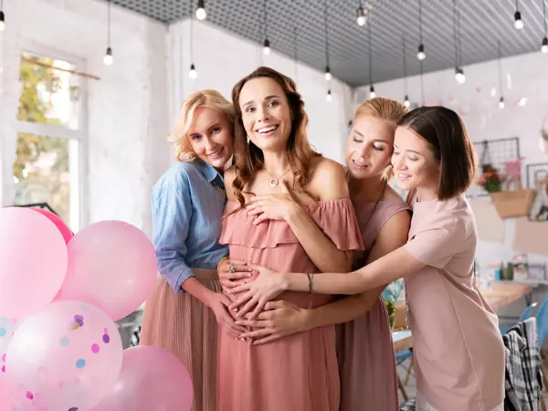 So many presents. Smiling pregnant woman feeling extremely surprised seeing so many presents