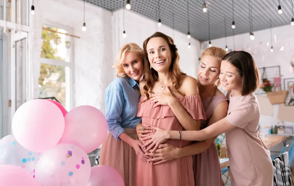 So many presents. Smiling pregnant woman feeling extremely surprised seeing so many presents