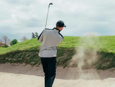 Mann som spiller golf