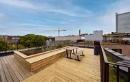 Felles takterrasse med tredekke, sitteplasser og utsikt over nærområdet.