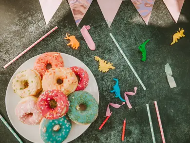 kid party table setting with colorful doughnuts