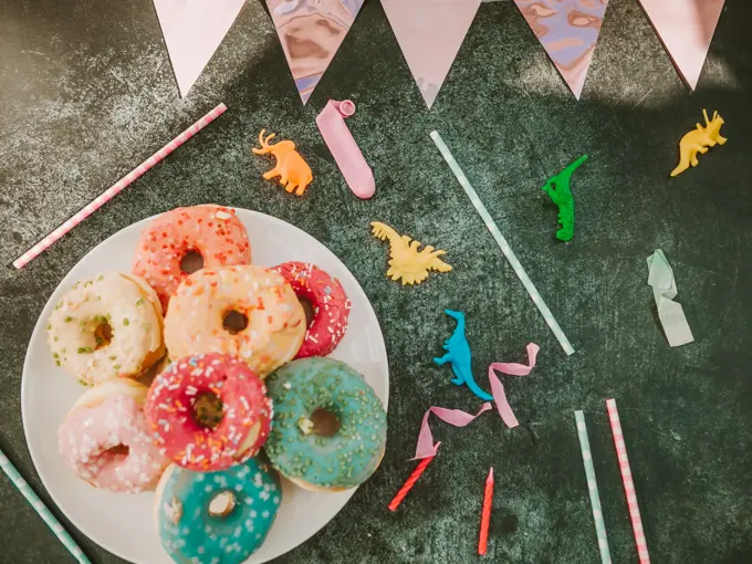 kid party table setting with colorful doughnuts