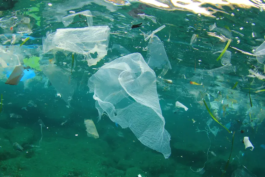 Et bilde under vann av masse søppel og plast.