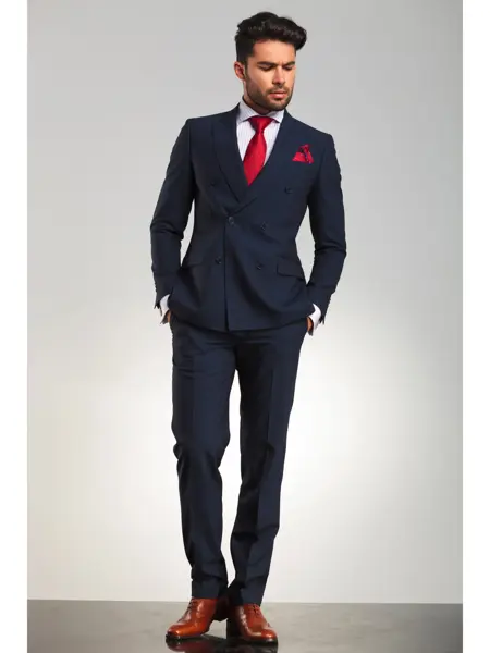 arrogant elegant man in double breasted suit standing with hands in pockets and looks to side on grey studio background