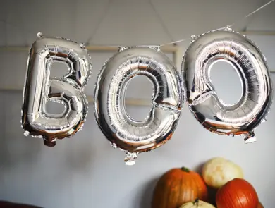 Silver balloons that spell the word 'boo'