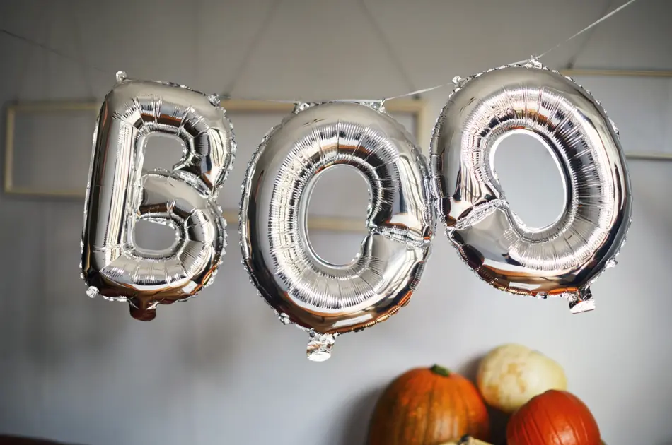 Silver balloons that spell the word 'boo'