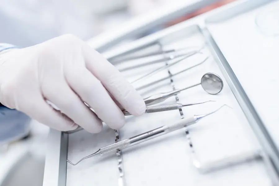 MODEL RELEASED. Close-up of dental equipment in dentists hand.