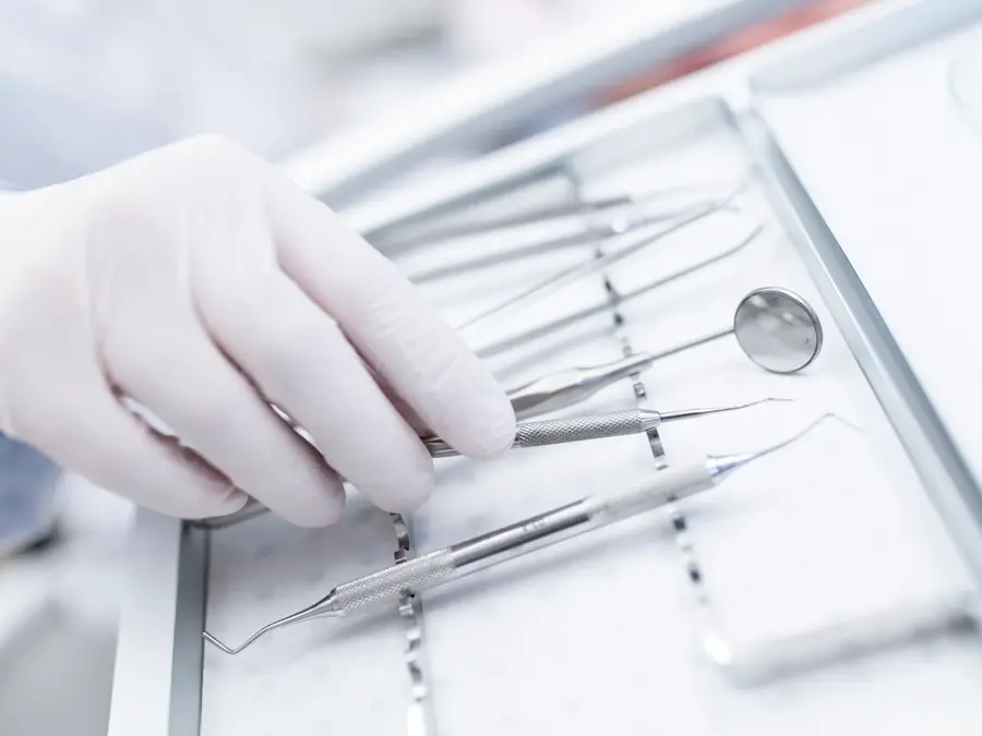 MODEL RELEASED. Close-up of dental equipment in dentists hand.