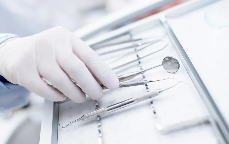 MODEL RELEASED. Close-up of dental equipment in dentists hand.