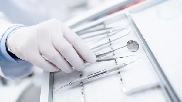 MODEL RELEASED. Close-up of dental equipment in dentists hand.