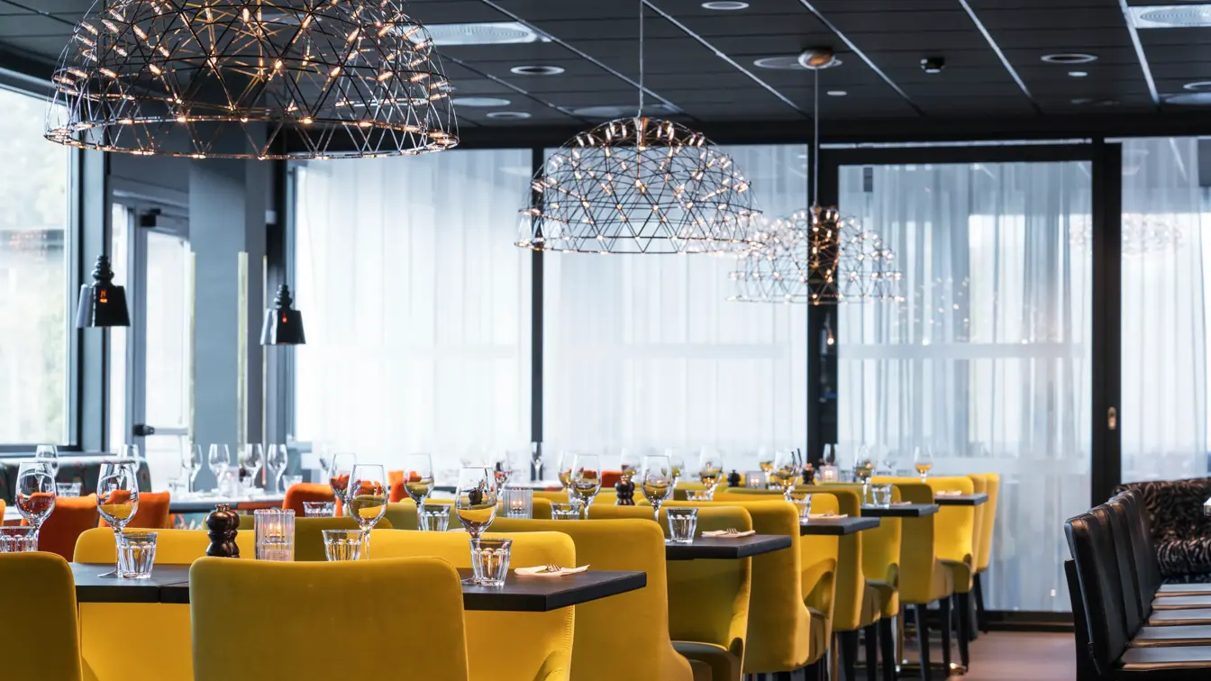 Frokostsal med ulikt design utrykk på stoler og vegger med forskjellige sittegrupper på Thon Hotel Oslo Airport ved Gardermoen