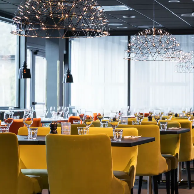 Frokostsal med ulikt design utrykk på stoler og vegger med forskjellige sittegrupper på Thon Hotel Oslo Airport ved Gardermoen