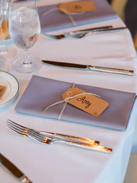Wedding reception seating with folded napkin name tags to create a seating assignment for this beautiful event.