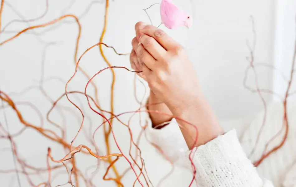 Woman decorating twigs