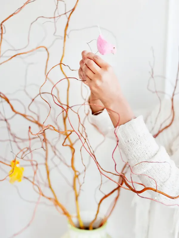 Woman decorating twigs