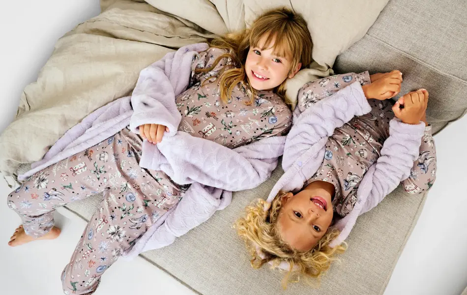 To jenter som ligger på en sofa