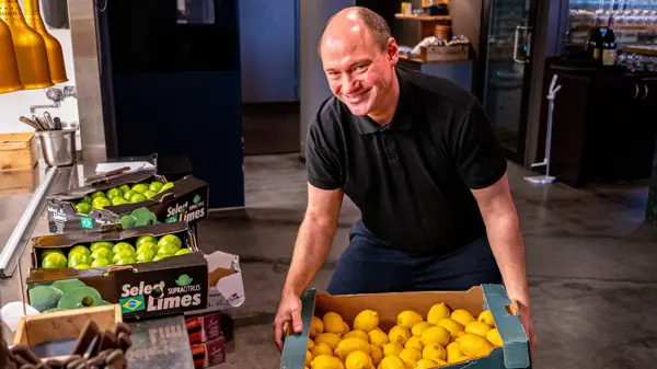 Mann som holder en kasse med sitroner