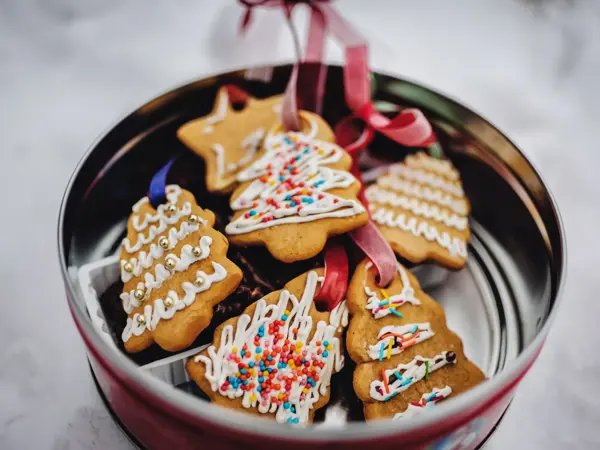 Plate with tasty Christmas cookies, gingerbread on snowy background with copy space for text. holiday, celebration and cooking concept. Happy new year and christmas. postcard.