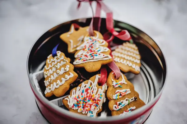 Plate with tasty Christmas cookies, gingerbread on snowy background with copy space for text. holiday, celebration and cooking concept. Happy new year and christmas. postcard.