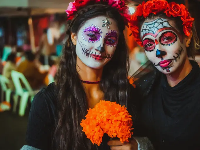 Portrait of a mother and daughter with traditional make up for Dia de los Muertos, Mexico