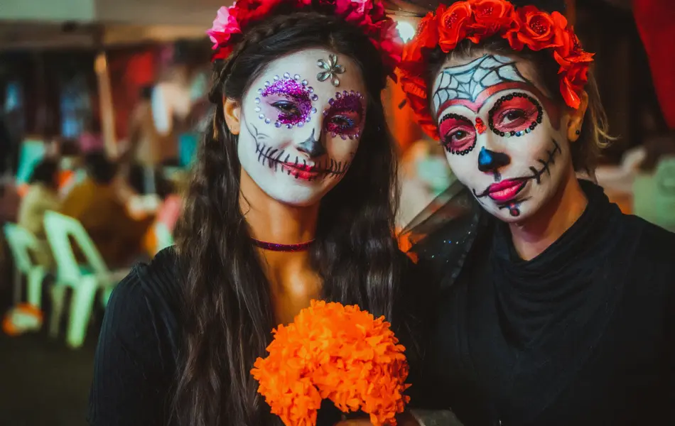 Portrait of a mother and daughter with traditional make up for Dia de los Muertos, Mexico