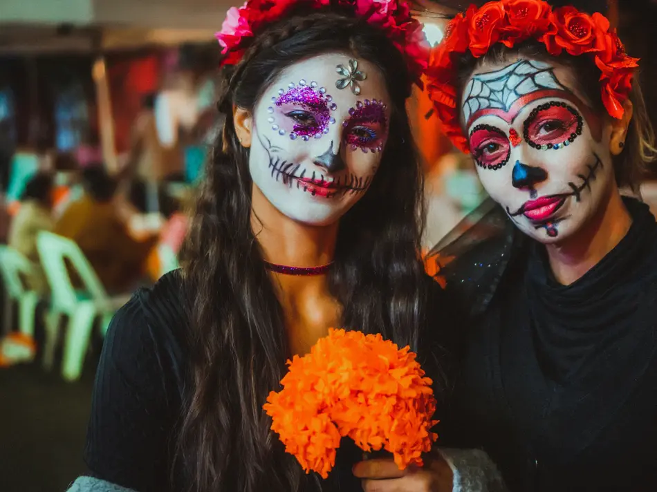 Portrait of a mother and daughter with traditional make up for Dia de los Muertos, Mexico
