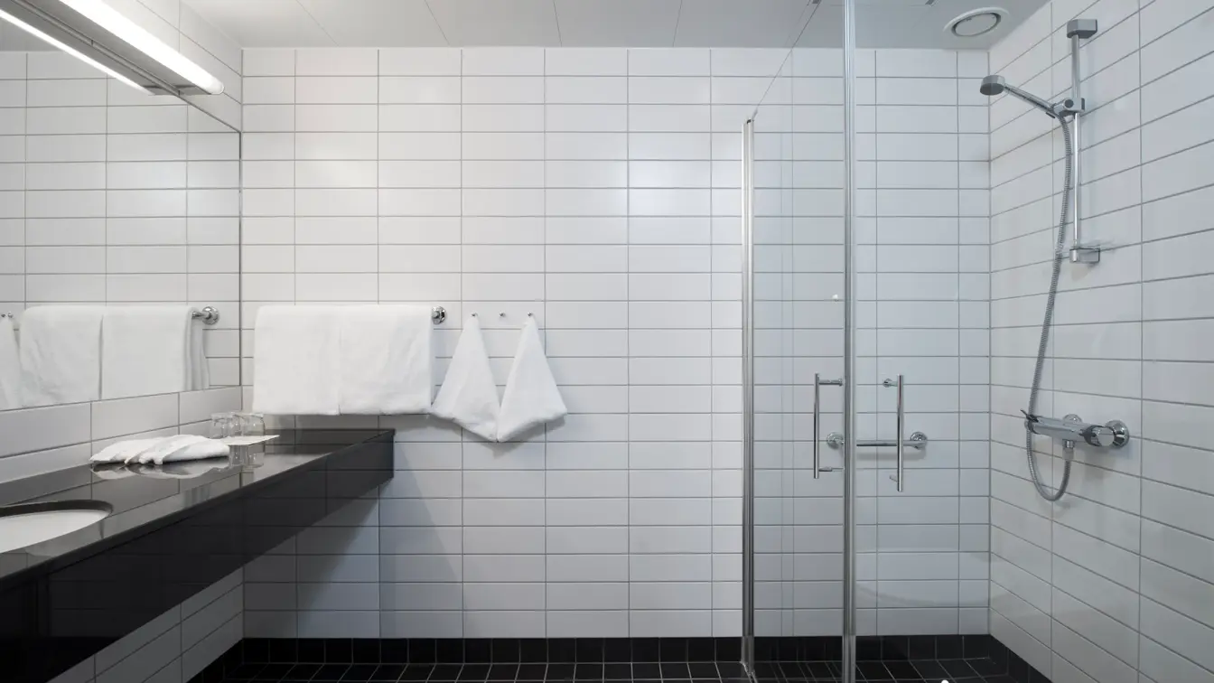 Bred vask og stort speil og dusj på standard room  på Thon Hotel Sandven