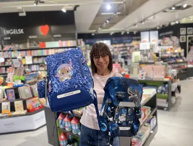 Ansatt som holder opp to ryggsekker