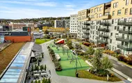 Thon Senter Triaden fasade, med lekeplass og uteservering.