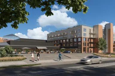 Fasadebilde av Triaden Helsehus på Lørenskog. Helsehuset vises i forkant og i bakgrunnen ser man kjøpesenteret Thon Senter Triaden.