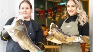 To jenter holder hver sin fisk